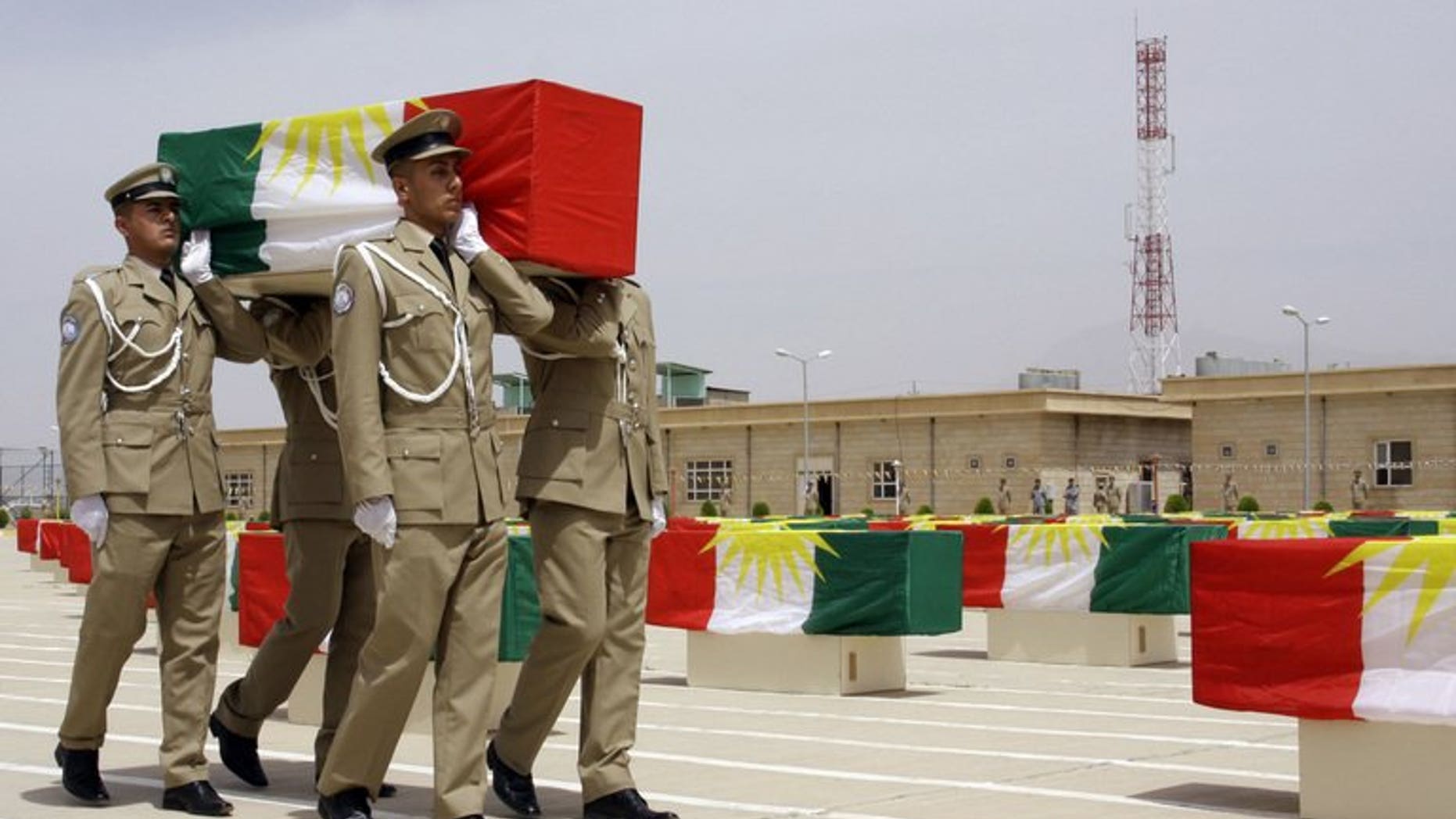 File picture shows Iraqi Kurdish police officers carrying a coffin draped with the Kurdish flag, on May 28, 2012. A suicide bomber killed eight Kurdish police in northern Iraq on Sunday, a district official and a doctor said.