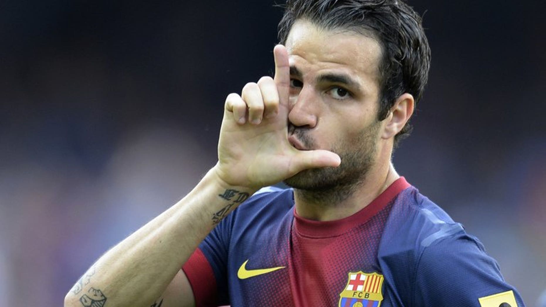 Barcelona's midfielder Cesc Fabregas celebrates after scoring a goal during the Spanish league at the Nou Camp stadium in Barcelona on June 1, 2013. Manchester United manager David Moyes on Sunday said he was confident of getting new players in before the end of the transfer window despite the impasse over Fabregas.