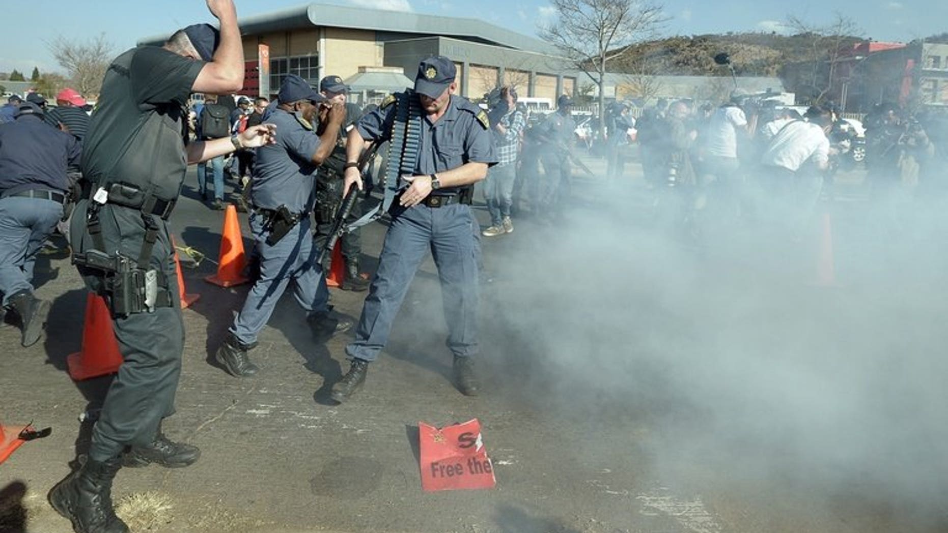 South African Police react after firing rubber bullets at protesters rallying against President Barack Obama's visit to South Africa, in Soweto on June 29, 2013. Almost 1,500 of South Africa's police officers have themselves committed crimes in a nation where security forces are notorious for brutality and corruption, according to an audit released Sunday.