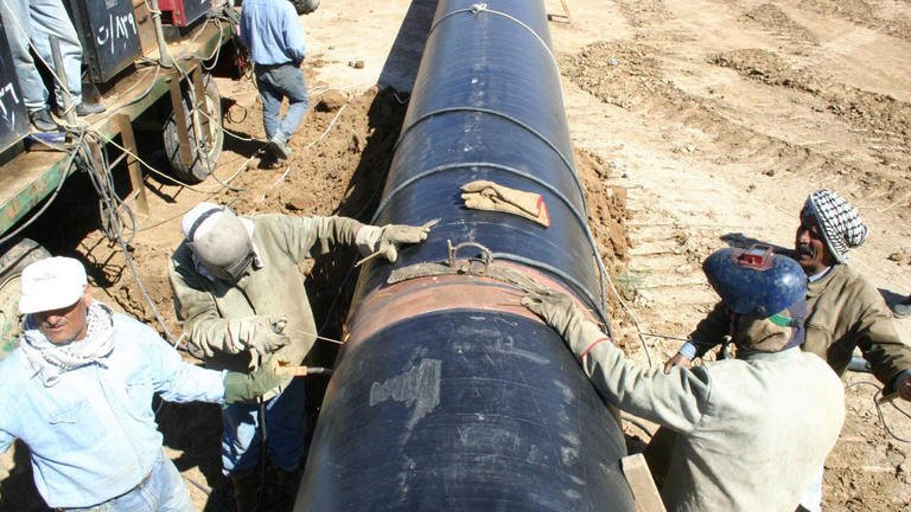 The Kirkuk-Turkey pipeline under repair in 2004. A bomb hit a pipeline carrying oil from Iraq to Turkey on Sunday, stopping exports, a police officer and a senior official from the North Oil Company said.