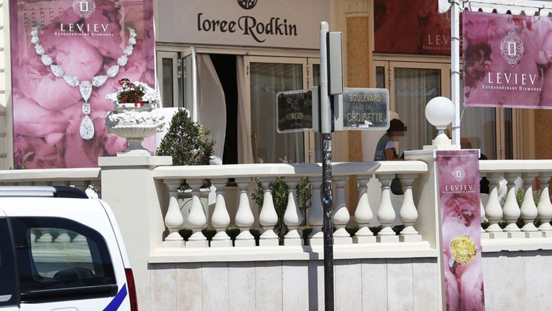 A French policeman investigates outside the Carlton Hotel on July 28, 2013 in the French Riviera resort of Cannes, after an armed man held up the jewellery exhibitionmaking away with jewels estimated to be worth about 40 million euros ($53 million).