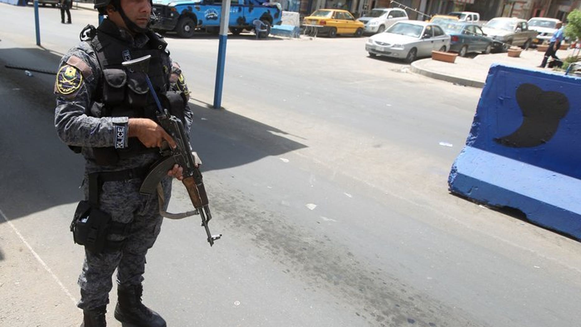 An Iraqi policeman mans a checkpoint on July 23, 2013 in the capital Baghdad. Car bombs mainly targeting Shiite-majority areas of Iraq killed at least 40 people on Monday, security and medical officials said, taking the July death toll to more than 770.