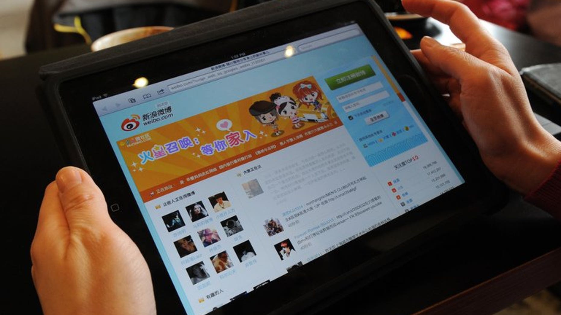 A woman views the Chinese social media website Weibo at a cafe in Beijing on April 2, 2012. A Chinese singer who was detained for threatening to bomb government offices after a man detonated a device at Beijing airport has triggered a debate about free speech.