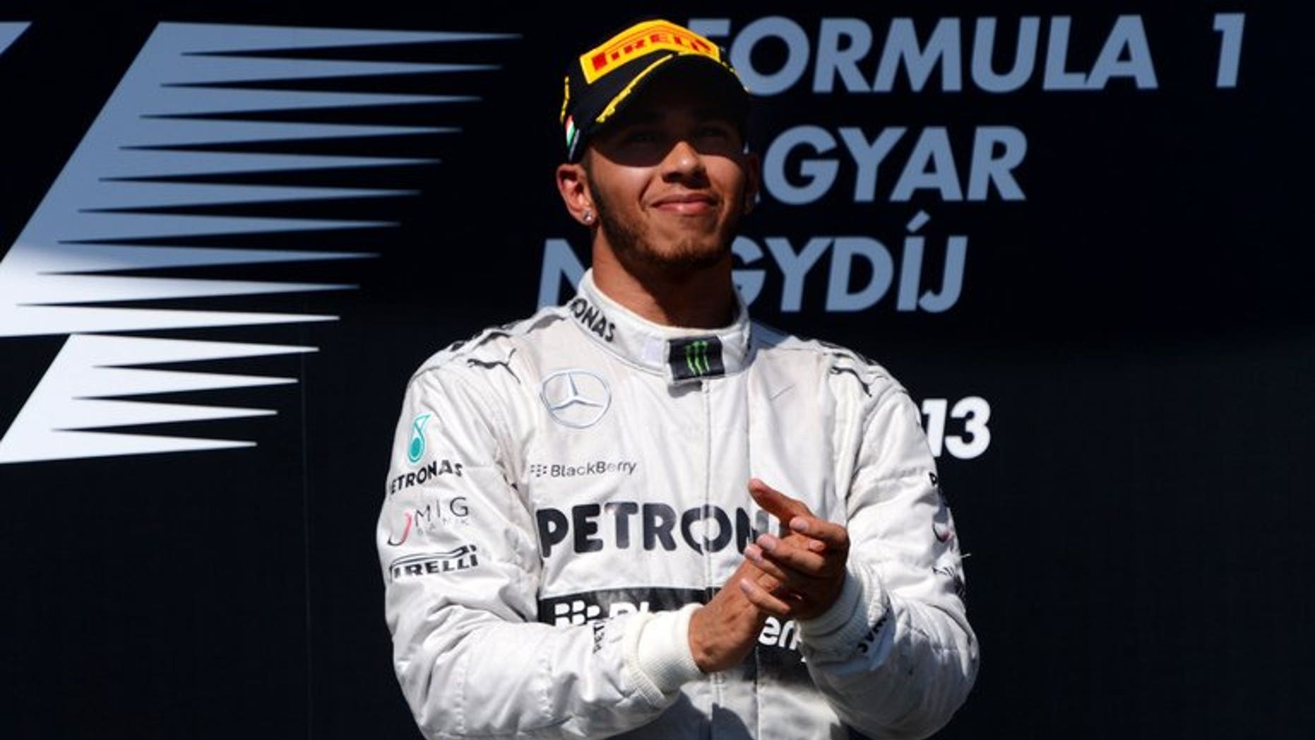 Mercedes' British driver Lewis Hamilton celebrates on the podium at the Hungaroring circuit in Budapest on July 28, 2013. Hamilton's faith in Mercedes was repaid by a victory that will give him the momentum to mount a title bid in the second half of the Formula One season, according to team chief Ross Brawn.