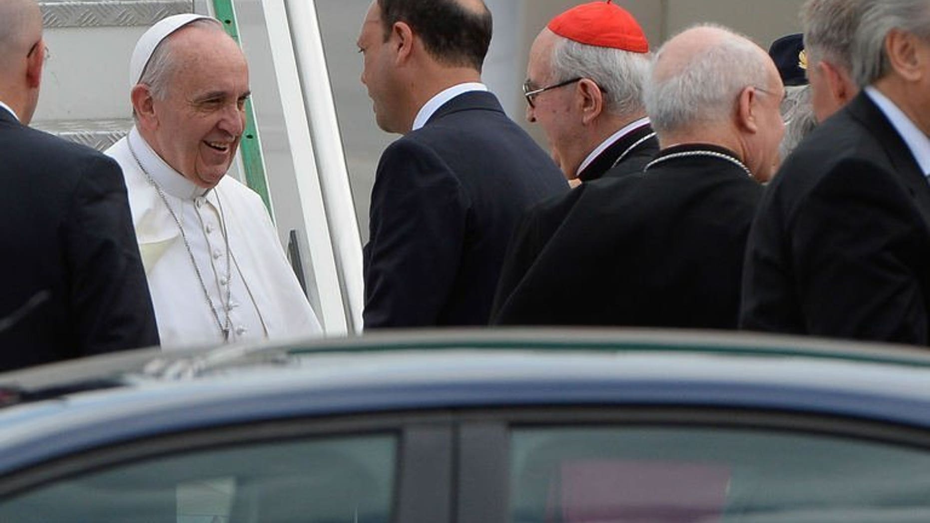Pope Francis (L) speaks with Italian interior minister and deputy premier Angelino Alfano (C) after disembarking from his plane at Rome's Ciampino international airport on July 29, 2013. Pope Francis on Monday condemned the gay lobby but said that homosexuals should not be marginalised.
