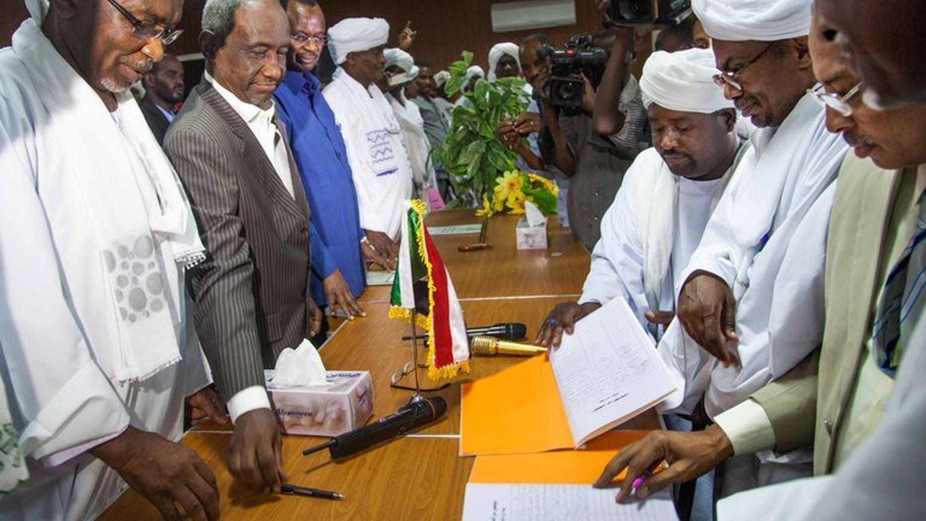 Government officials (left) with leaders of the Abbala and Beni Hussein tribes in El Fasher, N.Darfur, last week. Fighting between rival Arab tribes in Sudan's Darfur region spread on Monday, after clashes last week left scores dead, a leader of one of the tribes said.