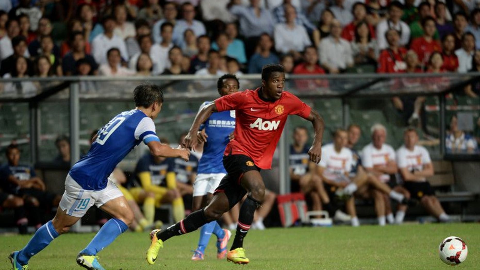 Danny Welbeck (right) of Manchester United runs for the ball against Hong Kong team Kitchee players during their friendly match at Hong Kong stadium on July 29, 2013. Manchester United saw off a spirited Kitchee 5-2 on Monday in Hong Kong to give David Moyes just his second victory as manager of the Premier League champions.