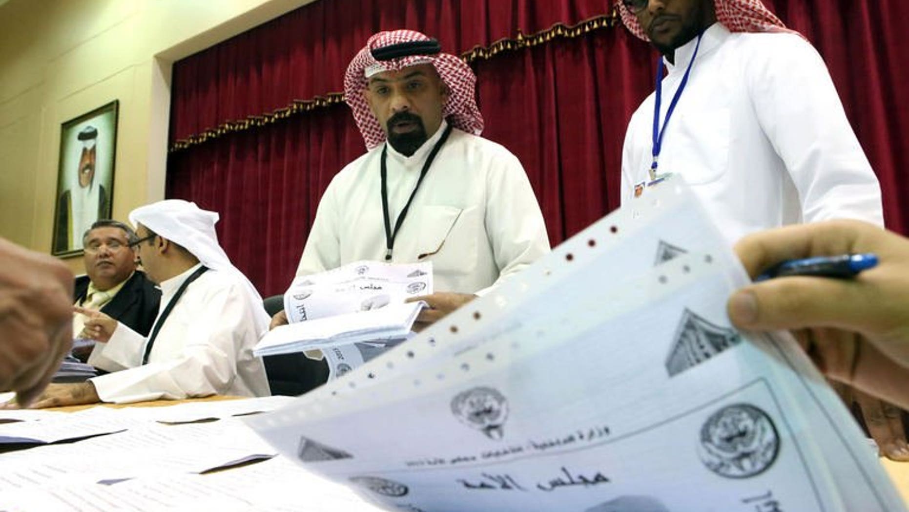 Kuwaiti judges and their aides count the ballots at a polling station after closure of voting in al-Khaldeyya district of Kuwait city, on July 27, 2013. Kuwait's Emir Sheikh Sabah al-Ahmad Al-Sabah on Monday asked the outgoing prime minister to form a new government following polls, the official KUNA news agency reported.