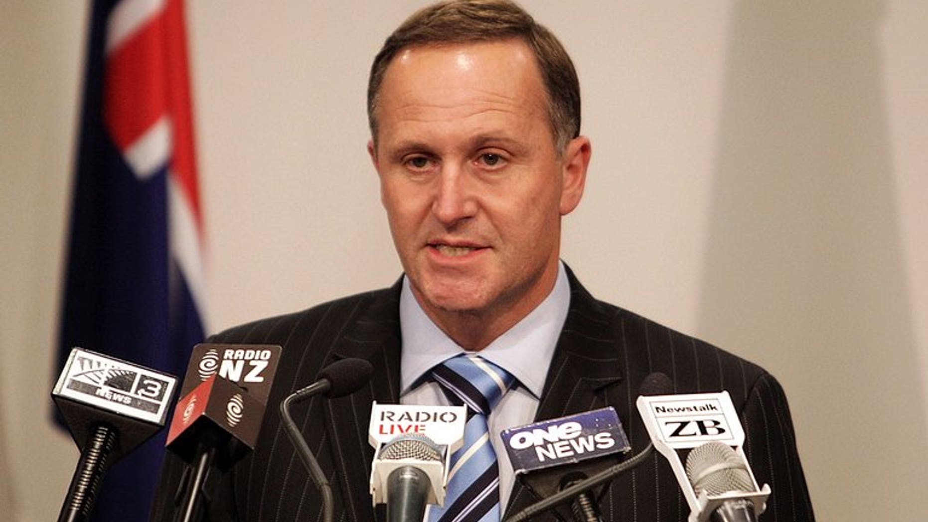 New Zealand's Prime Minister John Key speaks to the media in Wellington on October 27, 2010. The "hacktivist" group Anonymous briefly crashed Key's website in protest at plans to allow the country's intelligence agency to spy on local residents.