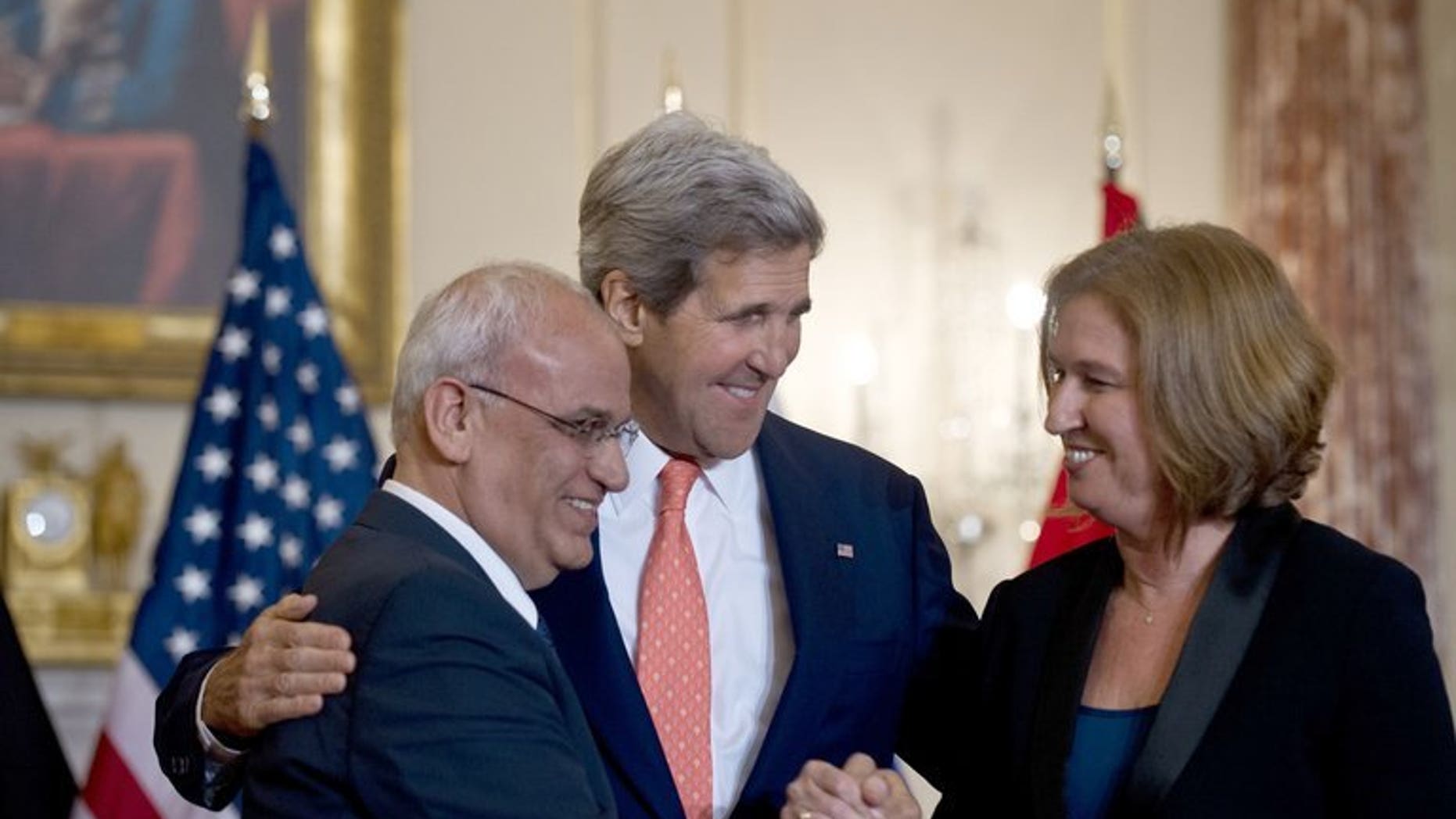 US Secretary of State John Kerry (centre) with chief Palestinian negotiator Saeb Erakat (left) and Israel's Justice Minister Tzipi Livni at the State Department in Washington, on July 30, 2013. Israeli and Palestinian negotiators' stated goal of reaching a comprehensive peace deal inside nine months is realistic, according to the European Union's top diplomat.