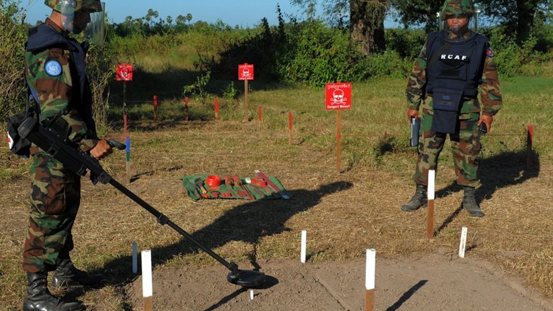 Cambodian soldiers scan for mines in Oudong, some 40 kilometers north of Phnom Penh, on November 27, 2011. Two Cambodian children and a man were killed when their buffalo cart hit an anti-tank mine left over from the country's civil war, police tell AFP.