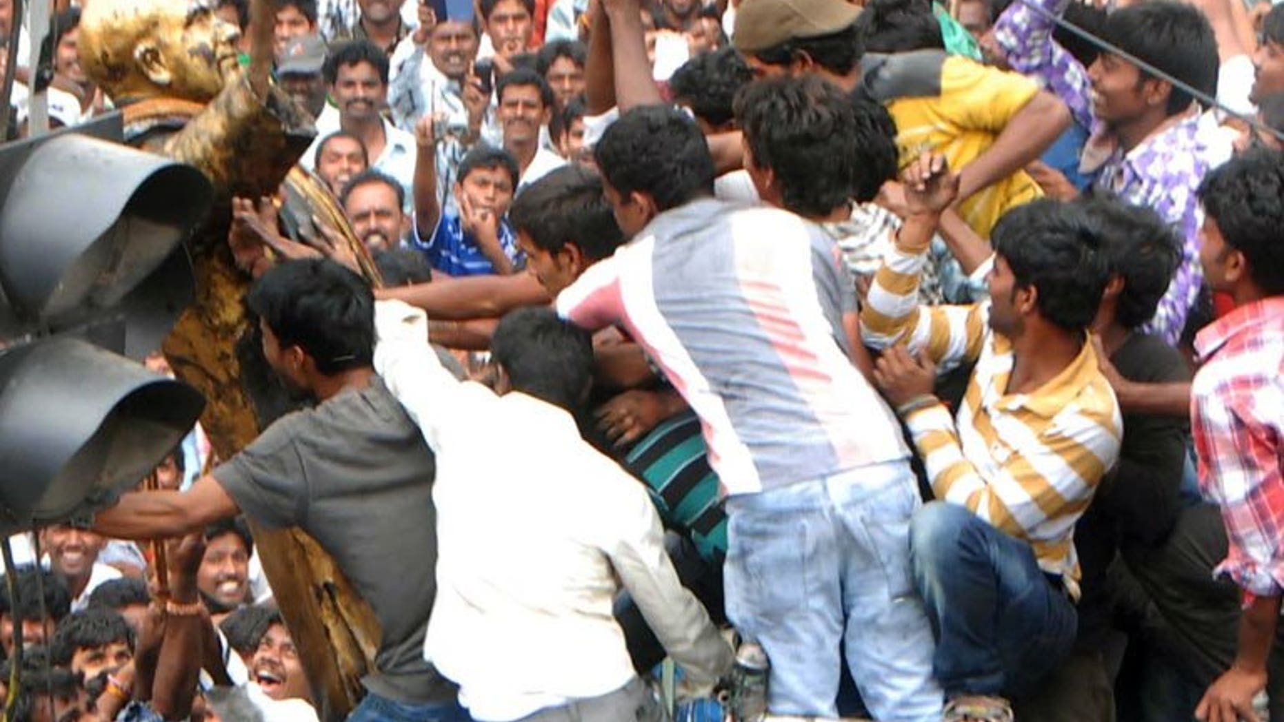 Andhra Pradesh activists tear down a statue of former Indian prime minister Rajiv Gandhi as they demonstrate against the formation of Telangana state in Ananthapur, on July 31, 2013. Protests have erupted in southeast India a day after the national ruling coalition approved the creation of a new state, leading to hundreds of arrests, police and reports said.