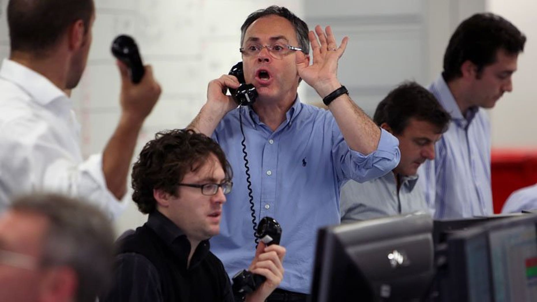 Brokers on ICAP's dealing floor in London. London shares closed higher on Thursday, lifted by strong results from Guinness maker Diageo as a flood of corporate results swept the market.