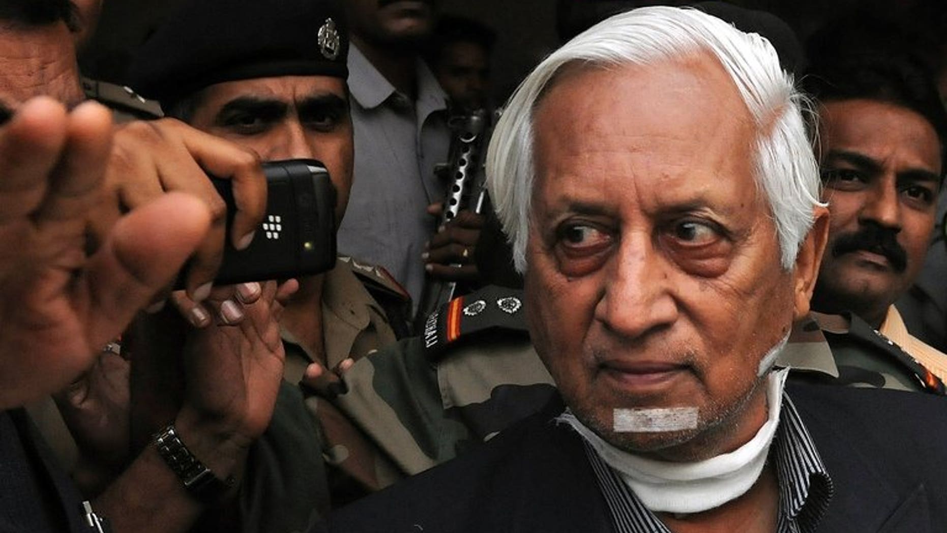 Retired Indian lieutenant general Kuldip Singh Brar is escorted out of the airport in Mumbai after his arrival from London on October 3, 2012. A Sikh gang was found guilty by a British court on Wednesday of slashing the throat of the Indian general, who oversaw the 1984 assault on Amritsar Golden Temple.