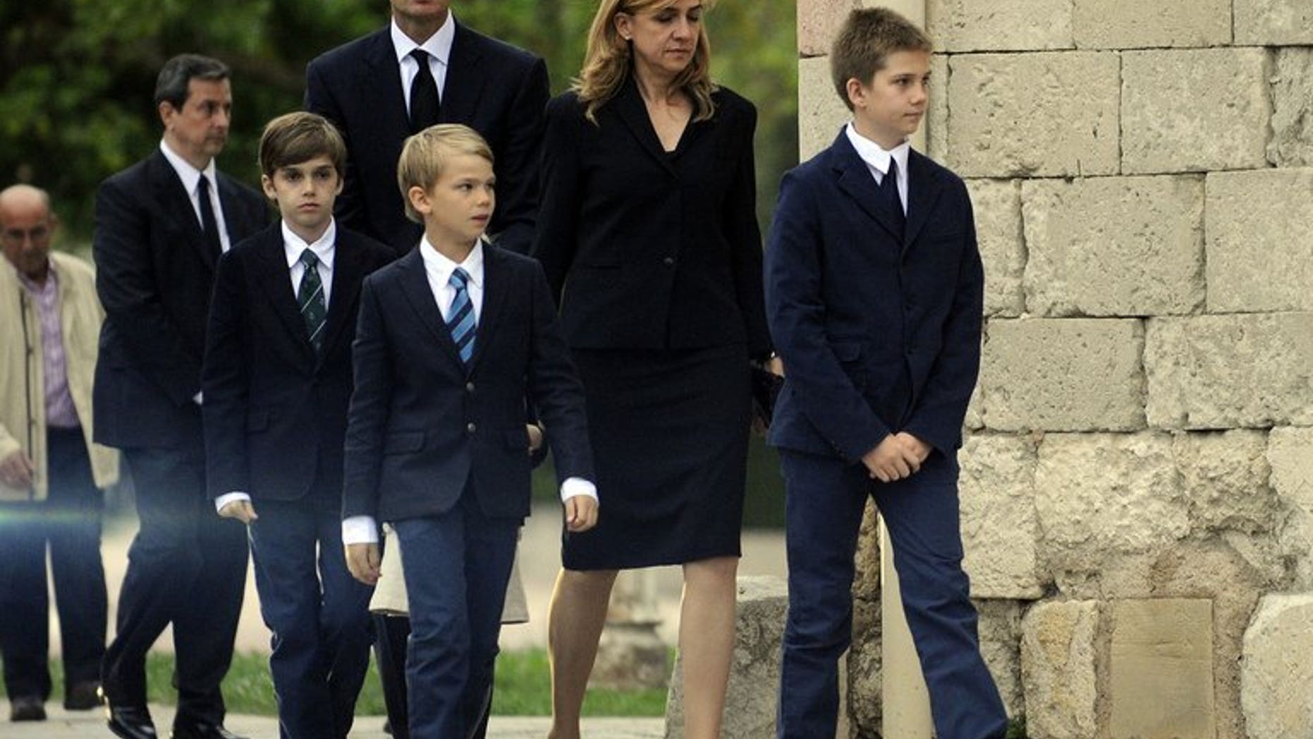 Spain's Duke of Palma Inaki Urdangarin (L), arrives with his wife Spain's Princess Cristina (C) and their four children at San Prudencio church in Vitoria, on May 12, 2012. Cristina is moving with her children to work in Switzerland, her employer said, two months after a court named her in a corruption case against her husband.