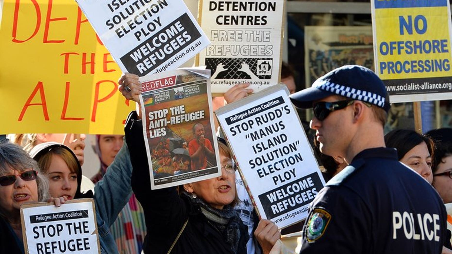 People protest against the Australian government's new policy of resettling refugees in Papua New Guinea, in Sydney on July 22, 2013.