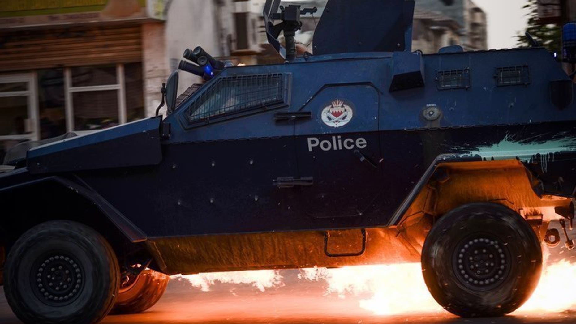 A Bahraini riot-police car is hit by a petrol bomb during clashes in the village of Saar, on June 26, 2013. Bahrain's King Hamad has decreed stiffer penalties for "terror acts" in the country rocked by a Shiite-led uprising since 2011, according to the official BNA news agency.