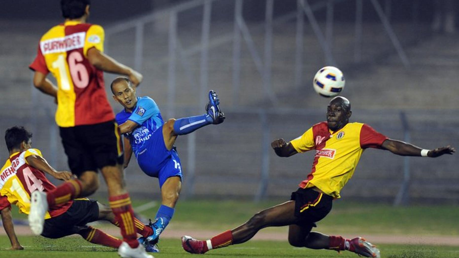 India's East Bengal players compete for the ball with Thailand's Chonburi's Chaiman Therdsak (centre) during their AFC Cup match at Salt Lake stadium in Kolkata on March 2, 2011. India's football chiefs backed a proposal to hold a new tournament inspired by cricket's popular Indian Premier League, despite fierce opposition from the country's top clubs.