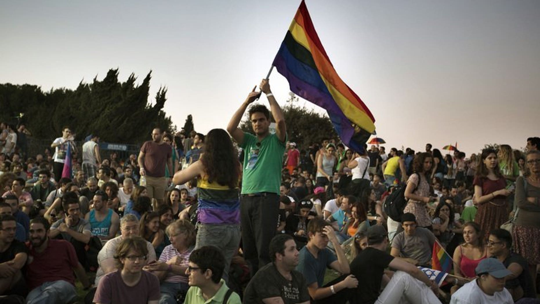 An Israeli waves a rainbow flag during the annual gay pride parade on August 1, 2013 in Jerusalem. A few thousand people marched in the gay pride parade in central Jerusalem without any serious incidents on Thursday, police said.