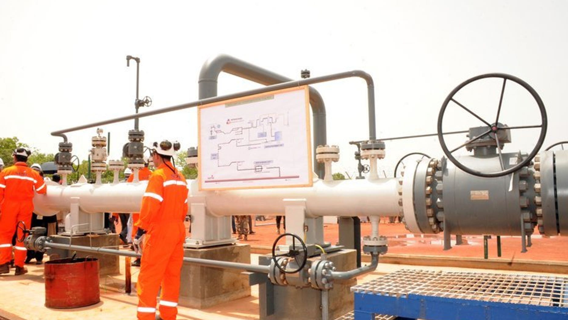 Technicians work next to an oil pipeline on June 9, 2013 in Badila, southern Chad. TransCanada announced plans for the construction of a $12 billion pipeline to carry oil from the Alberta oil sands to the Atlantic seaboard.
