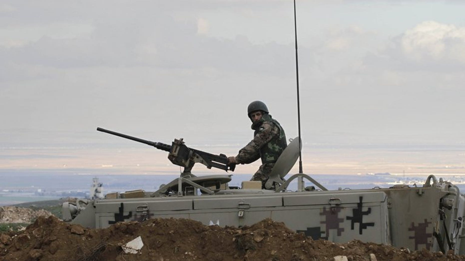 A Jordanian soldier keeps watch near Mafraq, on the border with Syria, on February 18, 2013. Jordan says its border guards have foiled an attempt to smuggle large amounts of weapons and drugs into the kingdom from Syria.