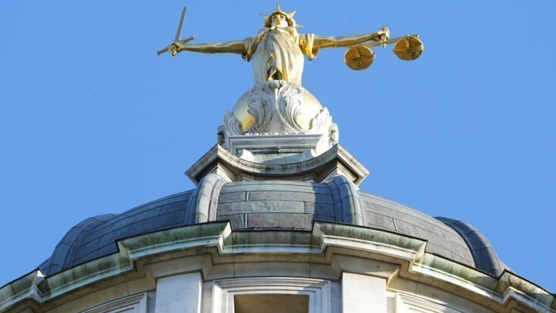 The statue of justice, on the roof of the Old Bailey, pictured on December 17, 2003 in London. Ten men accused of sexually exploiting teenage girls have been charged with offences including rape, sexual assault and trafficking, police said Friday.