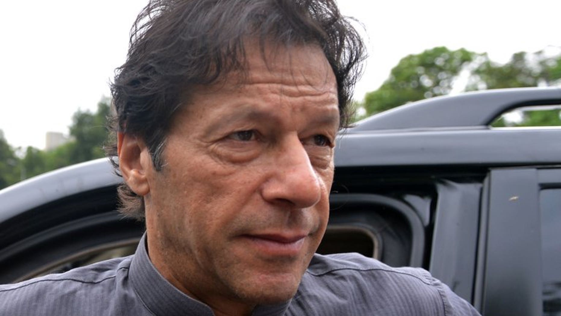 Pakistani politician Imran Khan arrives to appear before the Supreme Court in Islamabad, on August 2, 2013. The court has ordered the cricketer-turned-politician to respond in more detail over allegations that he committed contempt by making derogatory remarks against the judges.