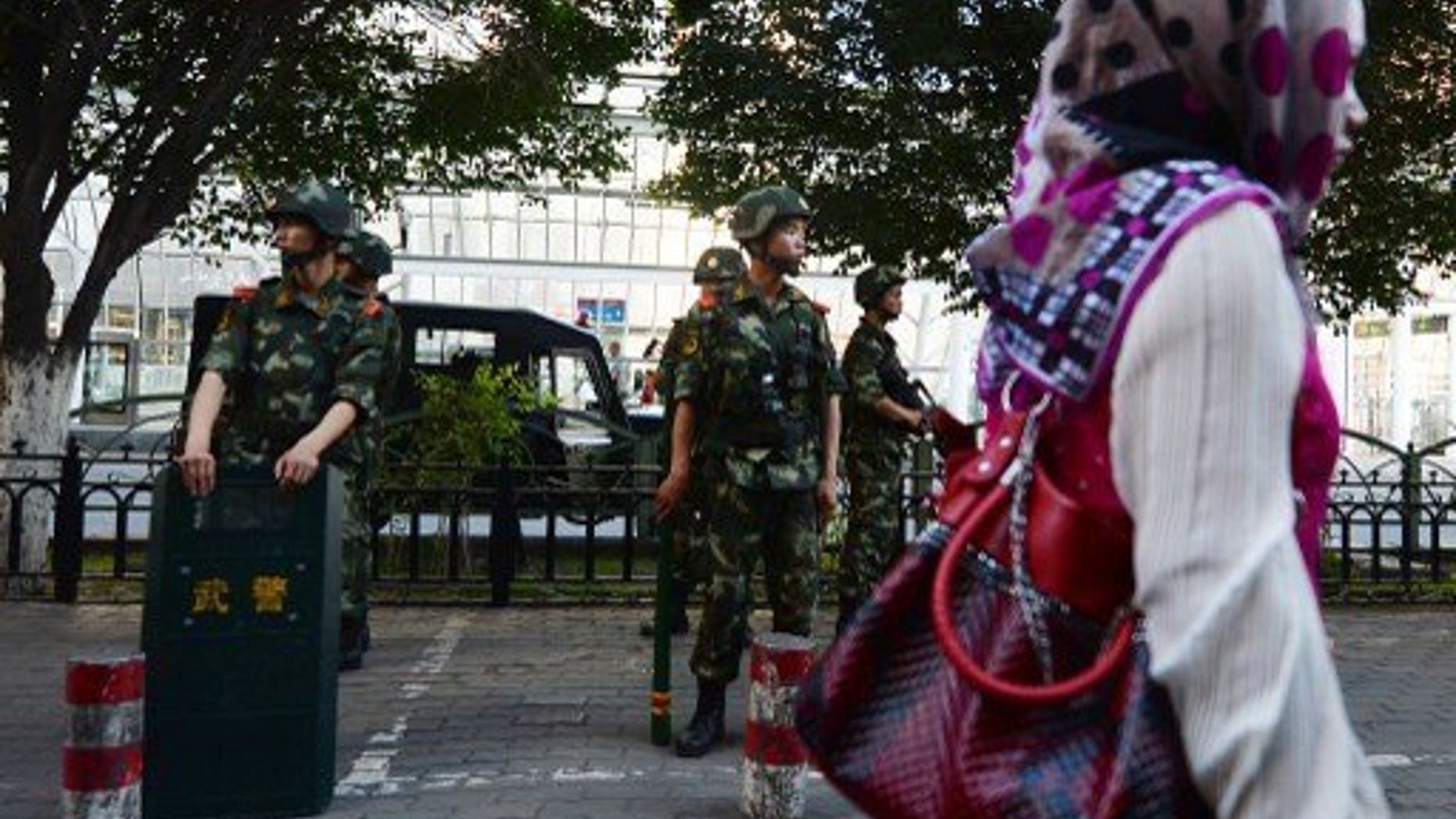 Chinese paramilitary police stand guard in the Muslim Uighur minority area of Urumqi, Xinjiang Province on June 30, 2013. Human rights conditions in China are worsening, a senior US official said Friday, accusing Beijing of harassing activists' family members and repressing ethnic and religious minorities.