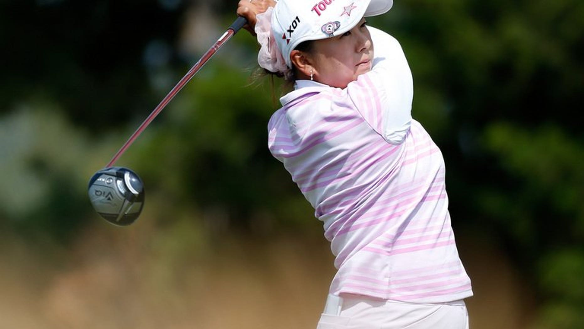 Miki Saiki of Japan watches her tee shot on the 15th hole at Sebonack Golf Club on June 28, 2013 in Southampton, New York. Saiki had a bundle of new experiences as she surged into the halfway lead on nine under par at the women's British Open at St Andrews on Friday.