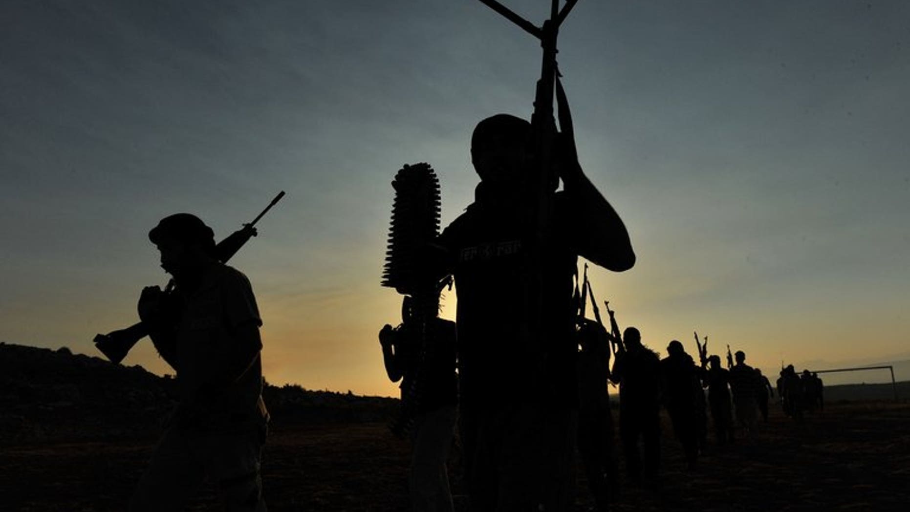 Jihadist militants take part in military exercises near Aleppo, on July 19, 2012.