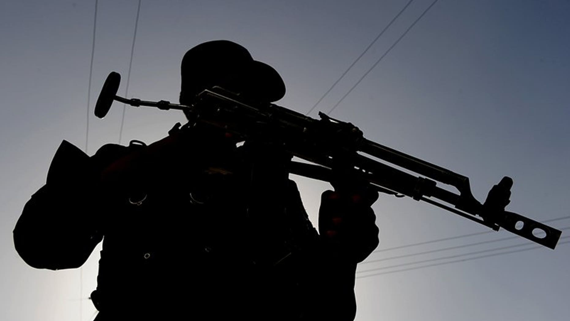 An Afghan policeman keeps watch at a checkpoint in Kabul. on July 19, 2010. More than 20 Afghan policemen and dozens of Taliban insurgents were killed when hundreds of fighters ambushed a police and military convoy in eastern Afghanistan.