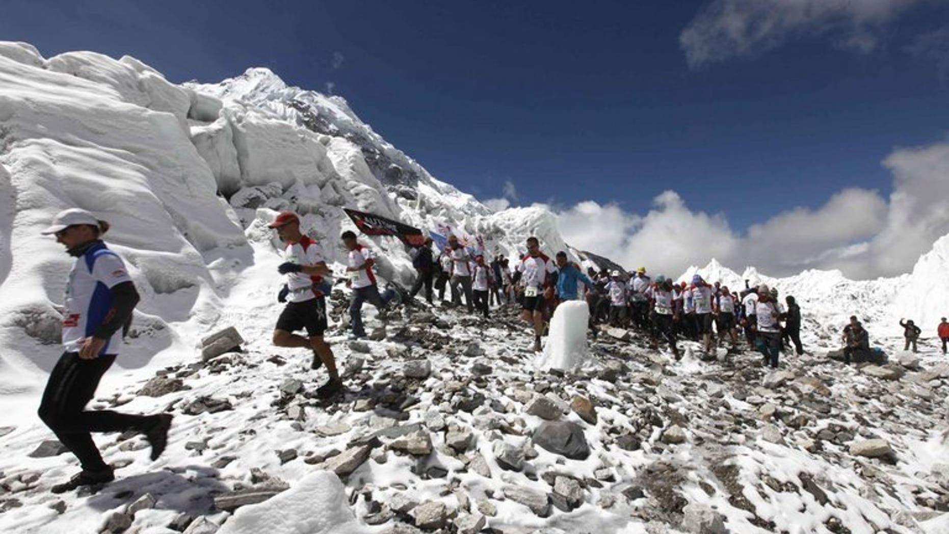 In this handout photograph released on May 29, 2013, marathon participatants are flagged off at Everest Base Camp in Nepal's Solukhumbu district. Nepal's tourism ministry said Friday it plans to exercise tighter control of climbers scaling Mount Everest to make sure they keep the world's highest peak clean and to prevent rows.
