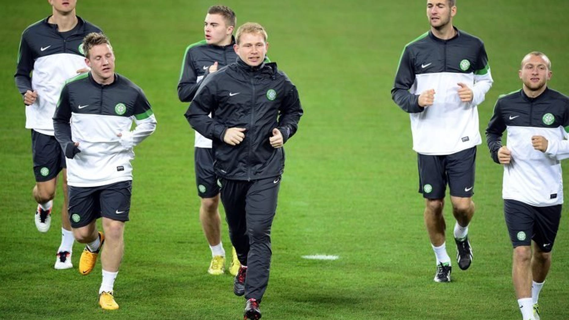 Celtic players warm up during a training session in Turin on March 5, 2013. Celtic will start the season as overwhelming favourites to capture the inaugural Scottish Premiership crown after cantering to the title last year.