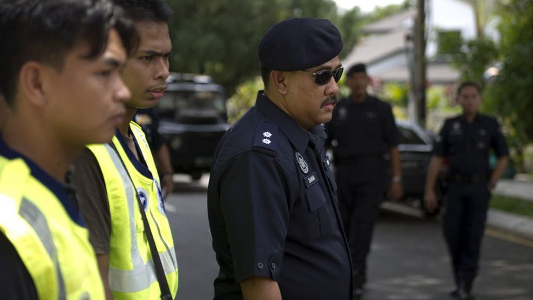 Malaysian police officers pictured during a road block in downtown Kuala Lumpur on March 16, 2012. Six family members who suffocated a Malaysian toddler to death by piling on top of her for hours in a suspected exorcism ritual have been fined but avoided jail, a report said Saturday.