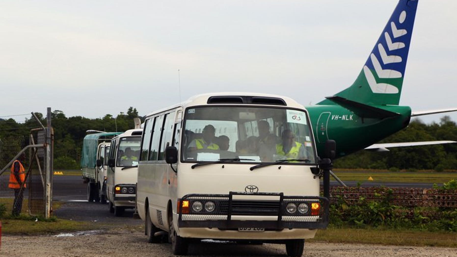Image taken by the Australian Government Department of Immigration and Citizenship on August 1, 2013 shows asylum-seekers being transported in buses after arriving in PNG. Australia expanded its plan banishing asylum-seekers arriving by boat to PNG Saturday to include Nauru island as national elections loom.