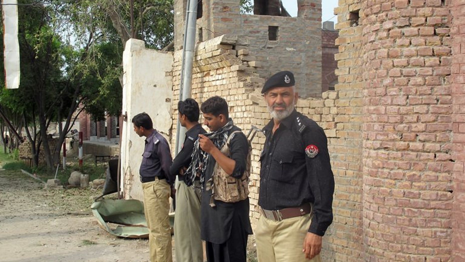 Pakistani policemen stand outside the Central Prison after an overnight armed Taliban militant attack in Dera Ismail Khan on July 30, 2013. The global police agency Interpol has said it suspected Al-Qaeda was involved in recent jailbreaks across nine countries, including Iraq, Libya and Pakistan.