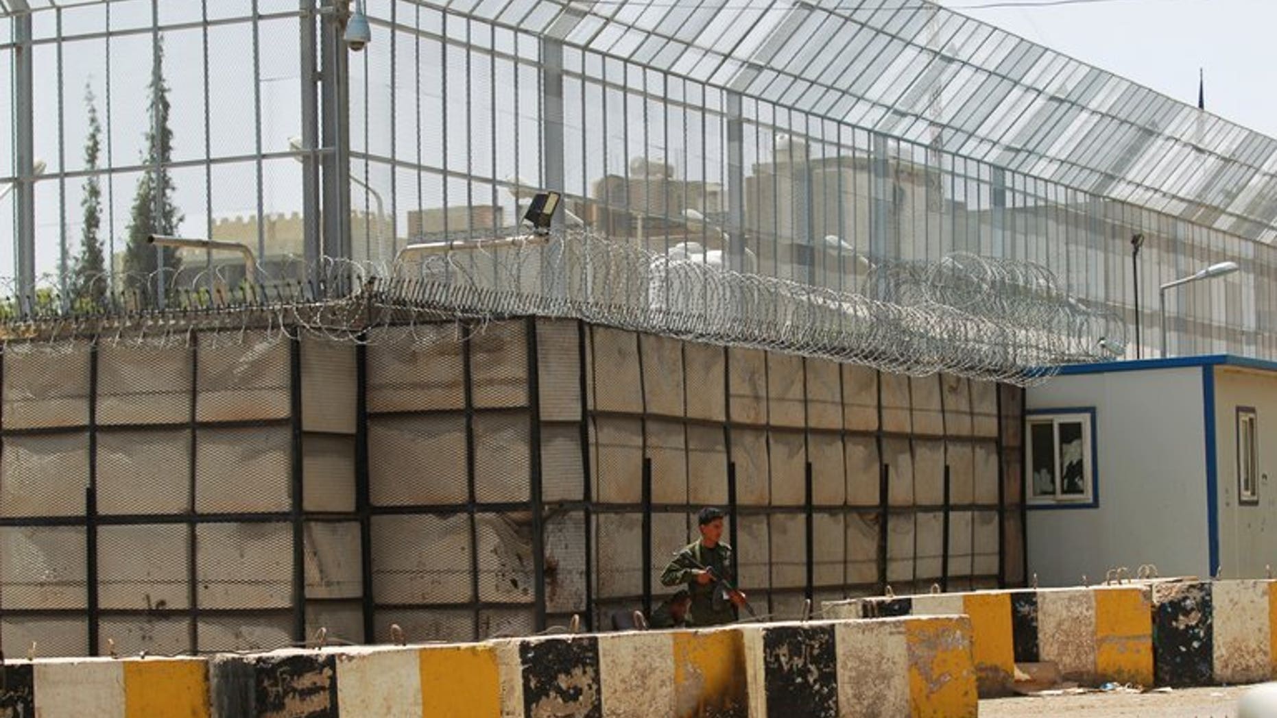 A Yemeni security officer stands guard outside the French embassy in Sanaa, on April 24, 2013. French President Francois Hollande has said France will close its embassy in Yemen over security fears for "several days", after Germany and Britain took the same precaution.