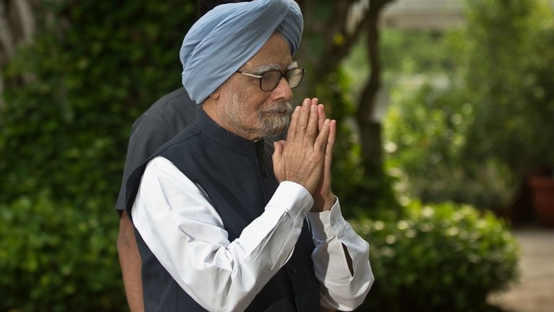 Indian Prime Minister Manmohan Singh gestures as he arrives for a meeting in New Delhi, on July 30, 2013. Singh has appealed to the opposition to make the next session of parliament "productive" after the last one was cut short by heated rows over allegations of government corruption.