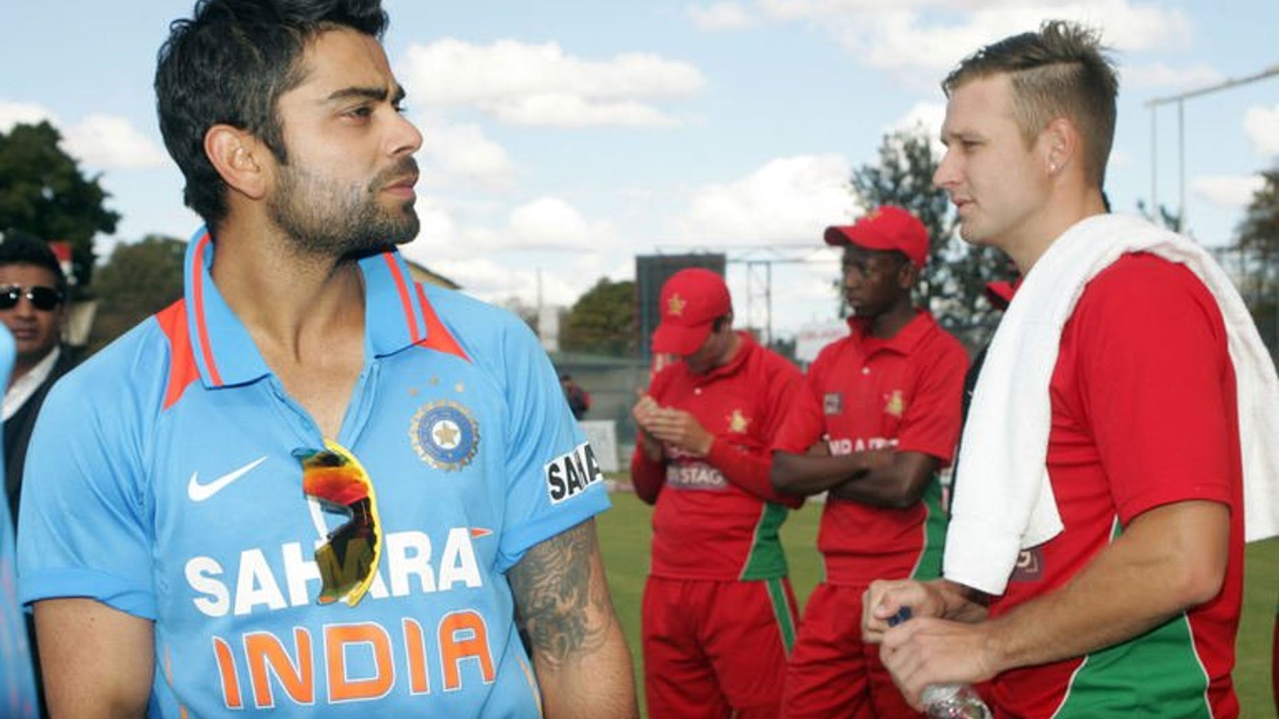 India captain Virat Kohli (L) stands with Zimbabwe bowler Kyle Jarvis at Queens Sports Club in Harare on August 3, 2013. Kohli believes that his young team will take plenty away from their 5-0 series sweep in Zimbabwe, despite the home side's inability to provide any meaningful challenge.