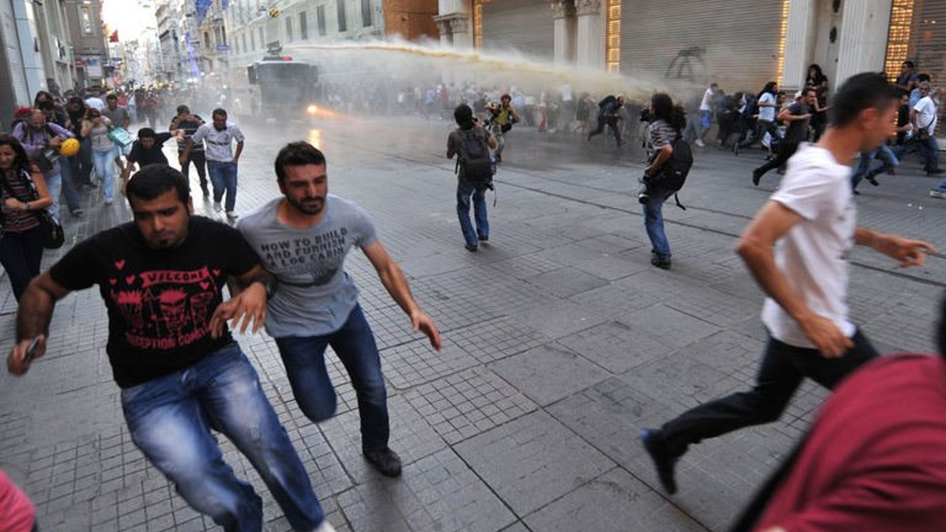 Turkish riot police use water cannon to disperse anti-goverment protestors during clashes at Istiklal street on August 3, 2013 in Istanbul.