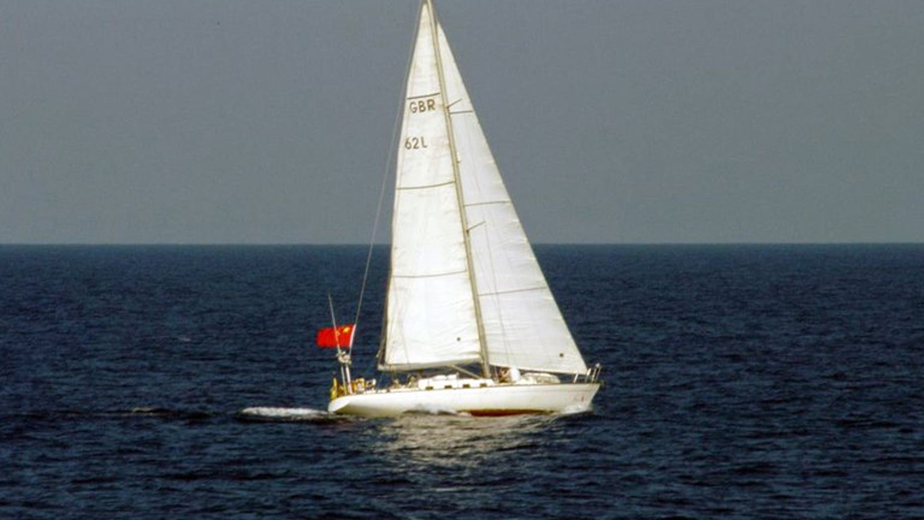 This photo, taken by Japan Coast Guard on August 3, 2013, shows a yacht of British registry carrying a Chinese flag as it cruises near the disputed islets known as the Senkaku islands in Japan and Diaoyu islands in China, in the East China Sea. The yacht entered Japan's territorial waters and sailers of the yacht threw a buoy with a red flag into the water and left the area.