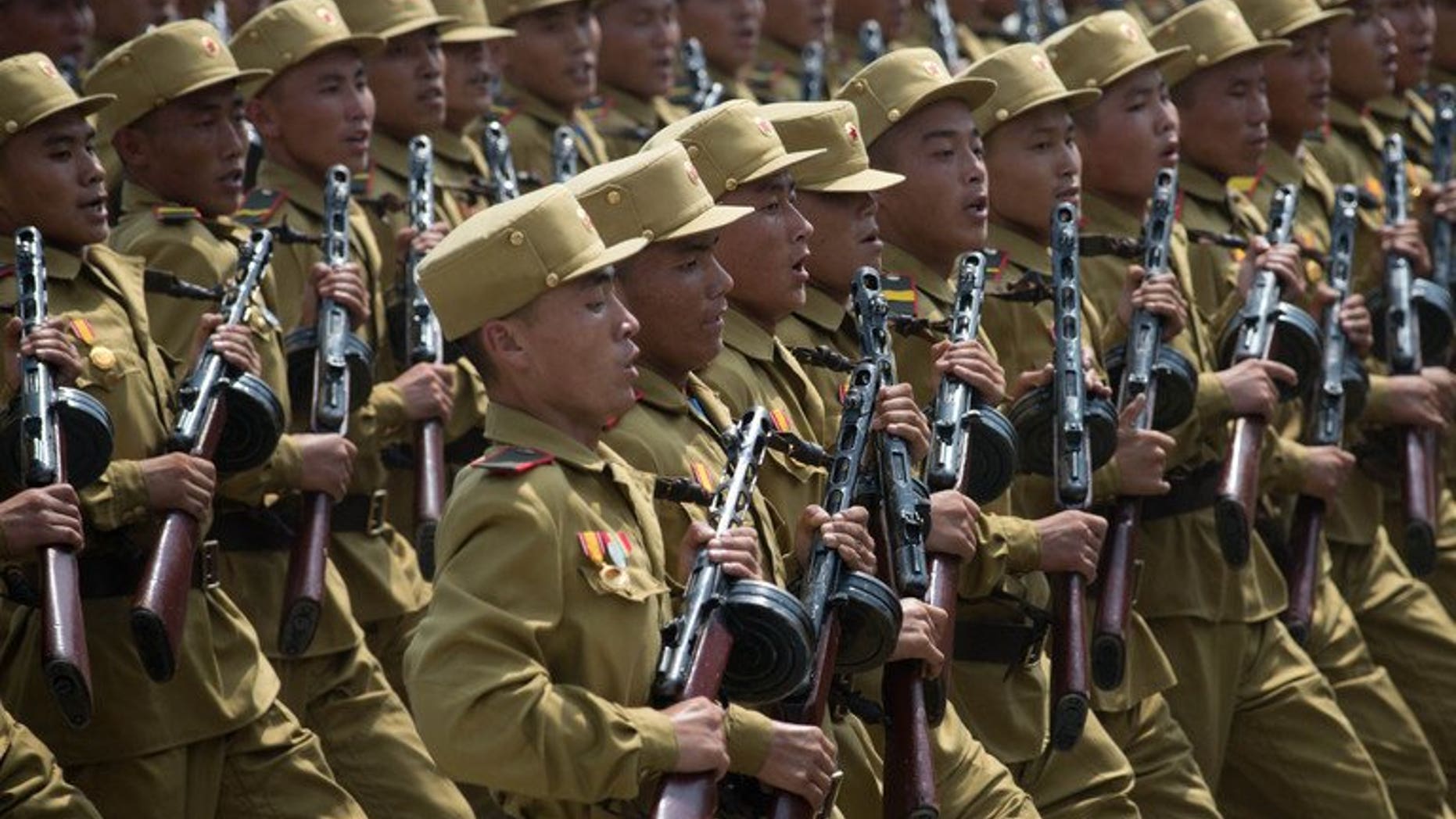 North Korean soldiers march through Kim Il-Sung square during a military parade, marking the 60th anniversary of the Korean war armistice, in Pyongyang, on July 27, 2013. N.Korea has cut short summer military drills to mobilise troops for flood relief efforts after torrential rains left dozens killed and ravaged farmlands nationwide, according to a S.Korean report.