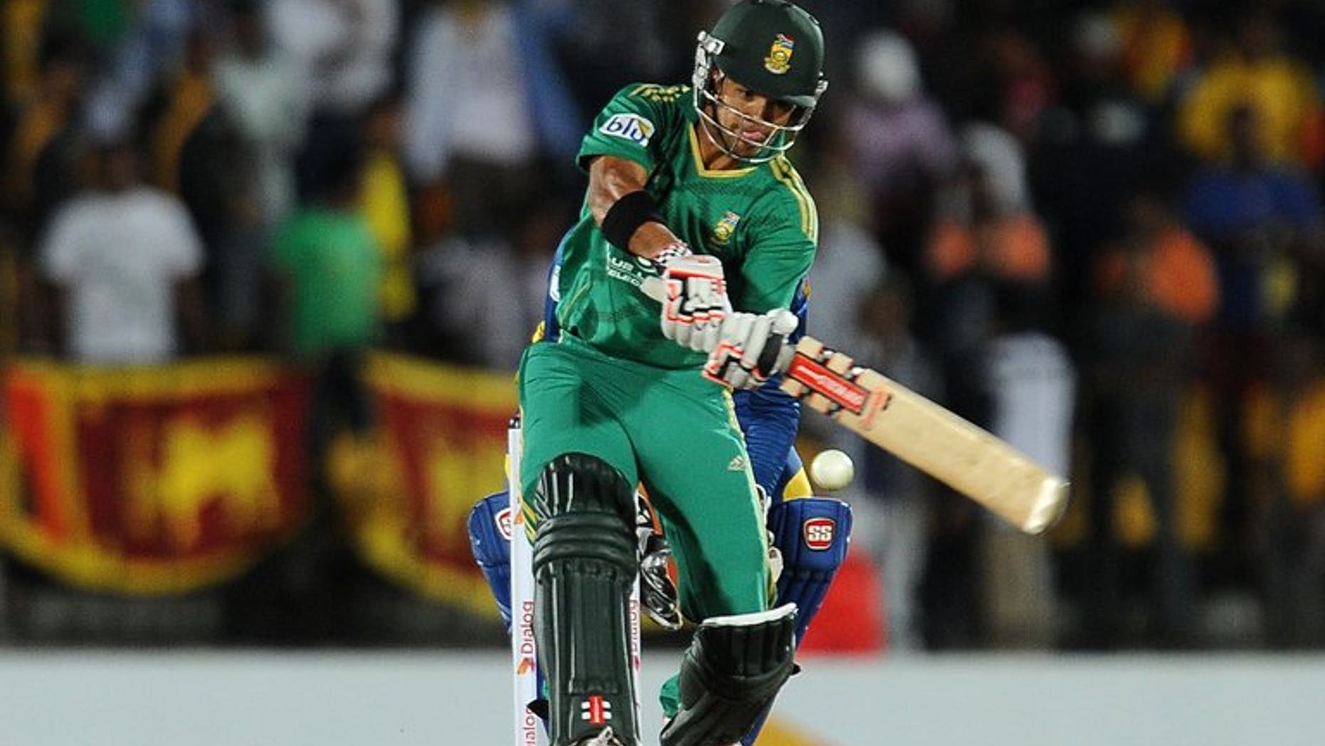 South African batsman JP Duminy plays a shot during the Twenty20 match against Sri Lanka in the district of Hambantota on August 4,2013. South Africa's captain Faf du Plessis won the toss and chose to bat in windy conditions in the second Twenty20 international against Sri Lanka in Hambantota