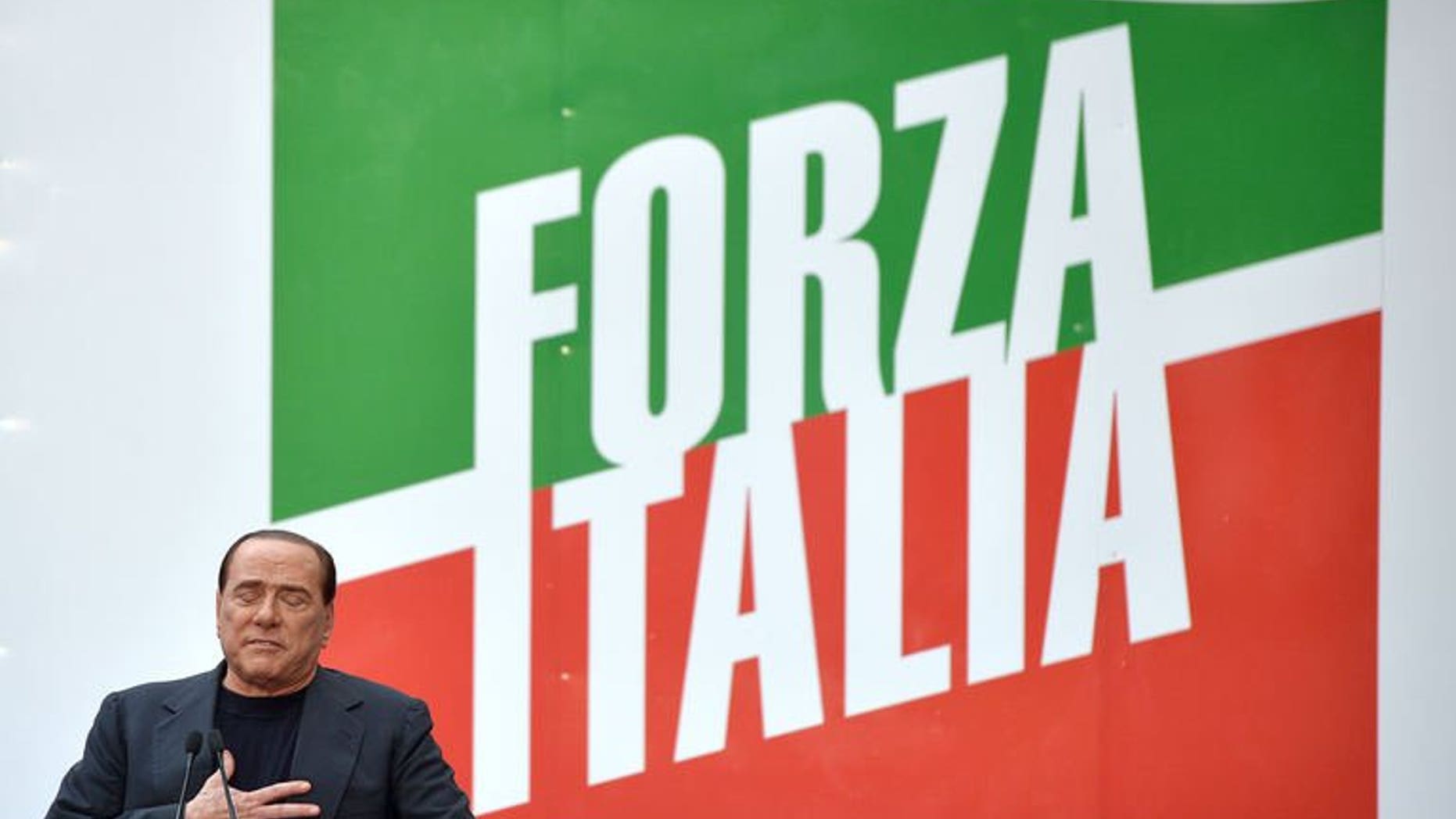 Former Italian premier Silvio Berlusconi attends a demonstration organized by the People of Freedom (PDL) party in his support, in front of his residence in Rome, on August 4, 2013. Berlusconi sought to allay fears Sunday over the future of Italy's uneasy coalition government after the former premier's tax fraud conviction sent shockwaves across the political scene.