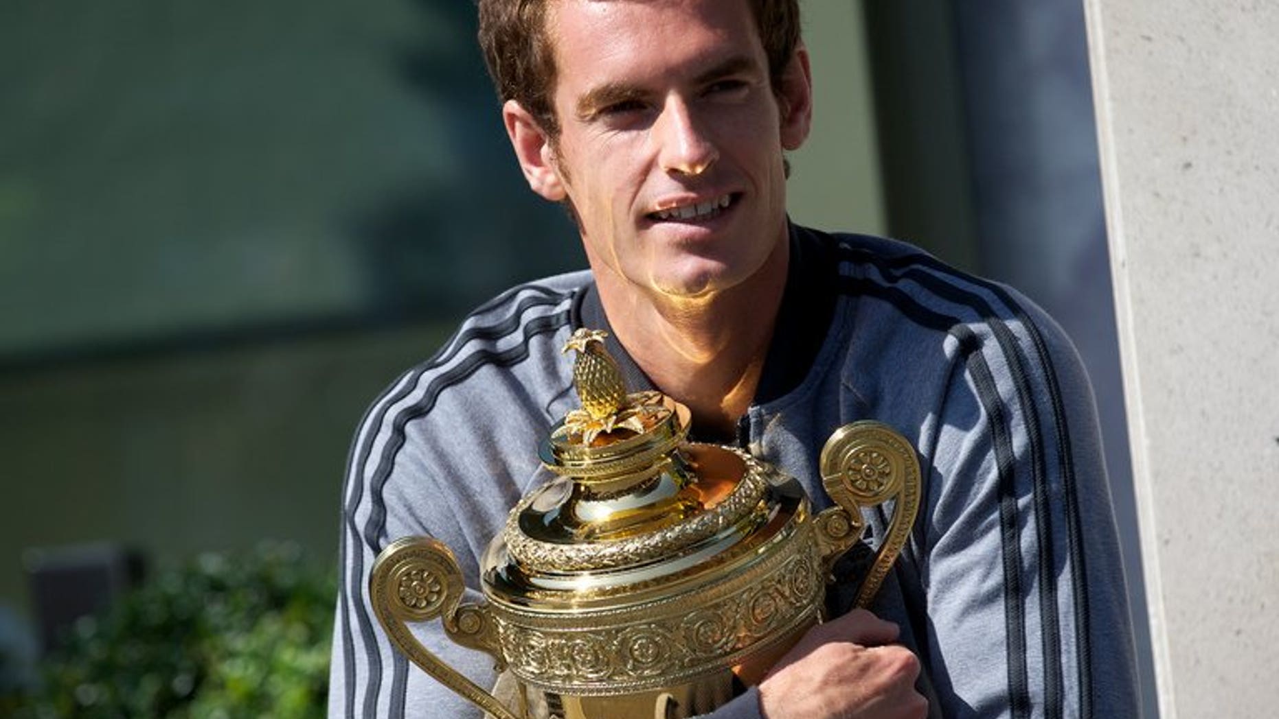 British tennis player Andy Murray poses with the 2013 Wimbledon trophy at the All England Club in Wimbledon, southwest London, on July 8, 2013. Murray admits that try as he might, he cannot keep the excitement and anticipation of his upcoming US Open title defence out of his mind at the Montreal Masters.