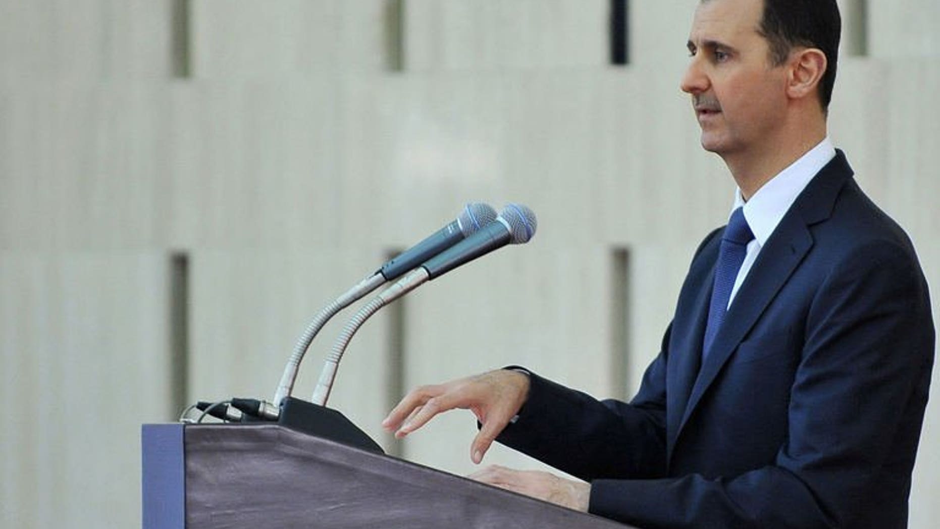 President Bashar al-Assad gives a speech at an "iftar" meal in Damascus on August 4, 2013. Syria's crisis will only be solved by stamping out "terror", al-Assad said, in reference to rebels fighting his regime.