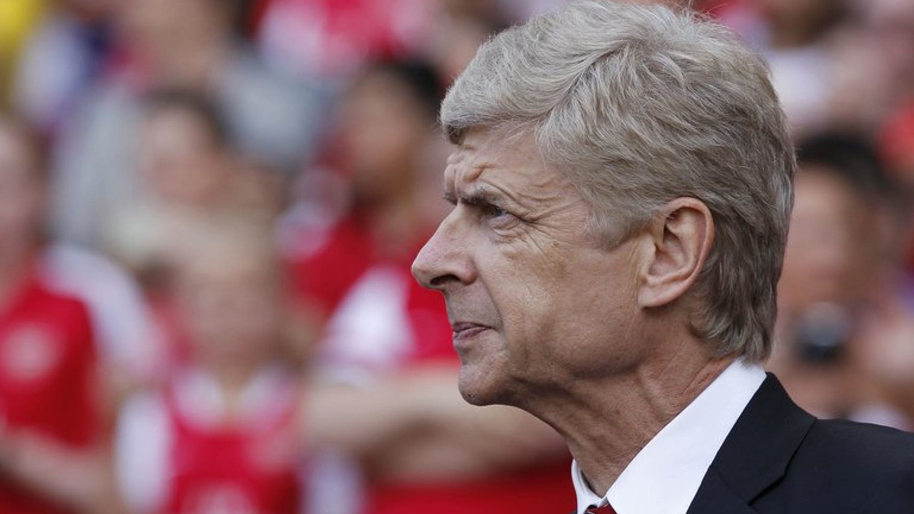 Arsenal's French manager Arsene Wenger looks on ahead of the pre-season friendly football match between Arsenal and Galatasaray at The Emirates Stadium in north London on August 4, 2013. Wenger admits Arsenal may be forced to go into their crucial Champions League qualifier without further additions to the squad.