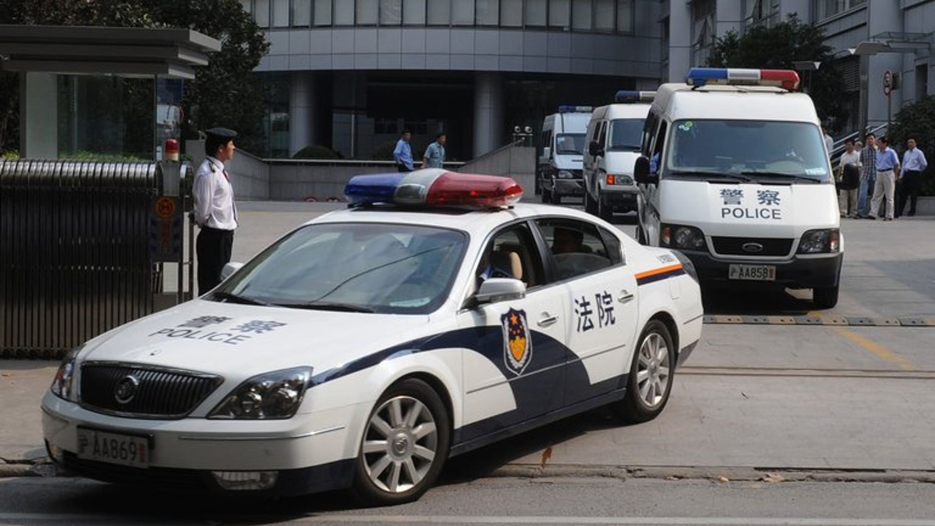 A police motorcade leaves the Shanghai Higher People's Court on October 20, 2008. The chief judge of the court's No.1 Civil Tribunal, and three other officials, have been suspended.