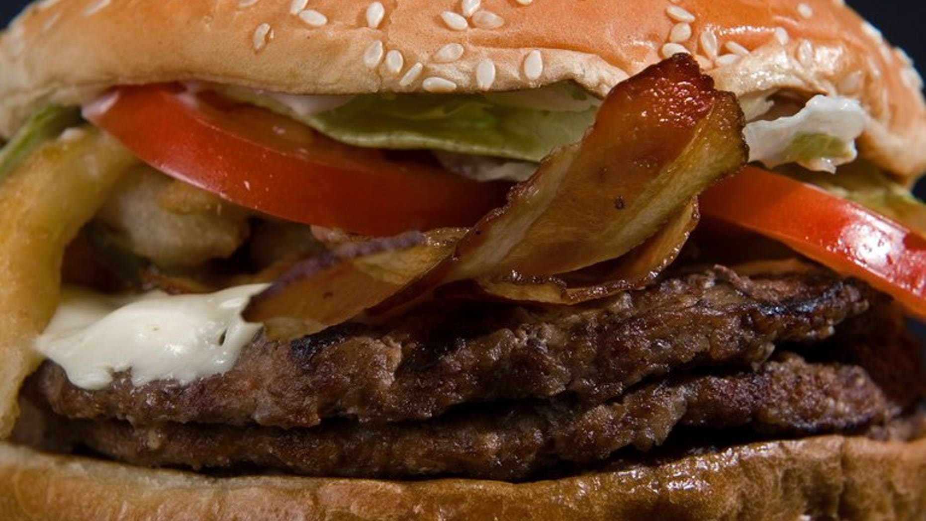 Scientists are set to unveil the world's first lab-grown beef burger, serving it up fried to volunteers in London in what they hope is the start of a food revolution. Researchers claim it will taste similar to a normal burger (pictured).
