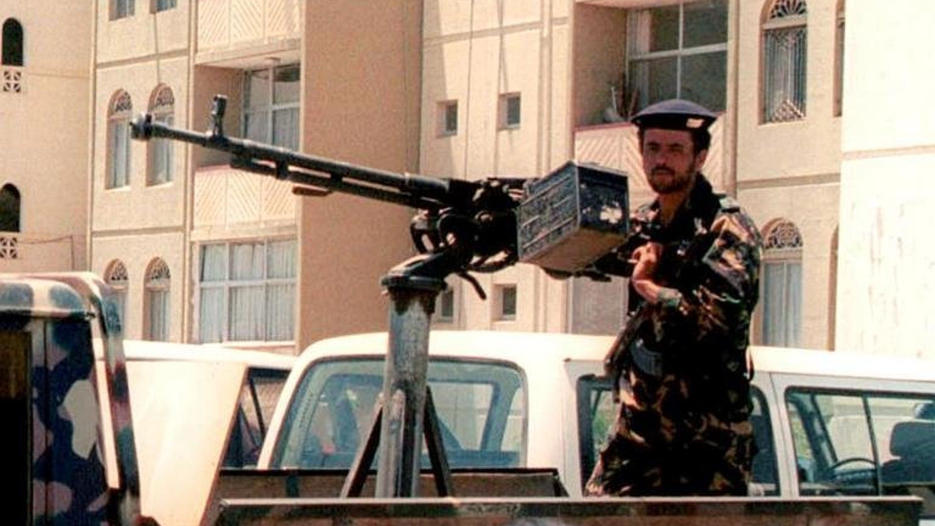 A Yemeni security officer mans a heavy gun outside the British embassy in the capital Sanaa in September 2002. Britain has said its embassy in Yemen would remain closed until the end of the Muslim festival of Eid later this week, after the United States extended the closure of its own embassies over fears of an Al-Qaeda attack.